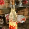 Lighted Wine Bottle With Swirling Glitter Hope Poinsettia Design With Cardinals Snow Globe 2 Lighted Wine Bottle With Swirling Glitter Hope Poinsettia Design With Cardinals Snow Globe -Battery Operated Candles Shop hope